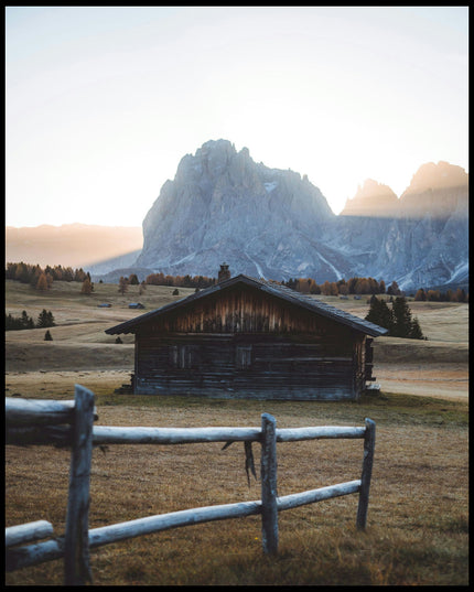 Ein Leinwandbild von einer rustikalen Hütte in einer herbstlichen Berglandschaft.