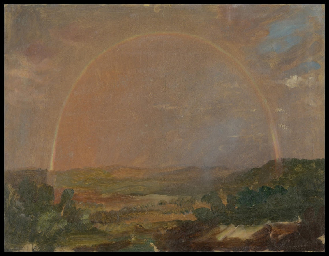 Arc-en-ciel sur un paysage vallonné