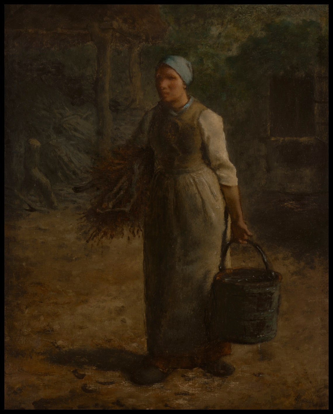 Femme portant un bois de chauffage et une paille