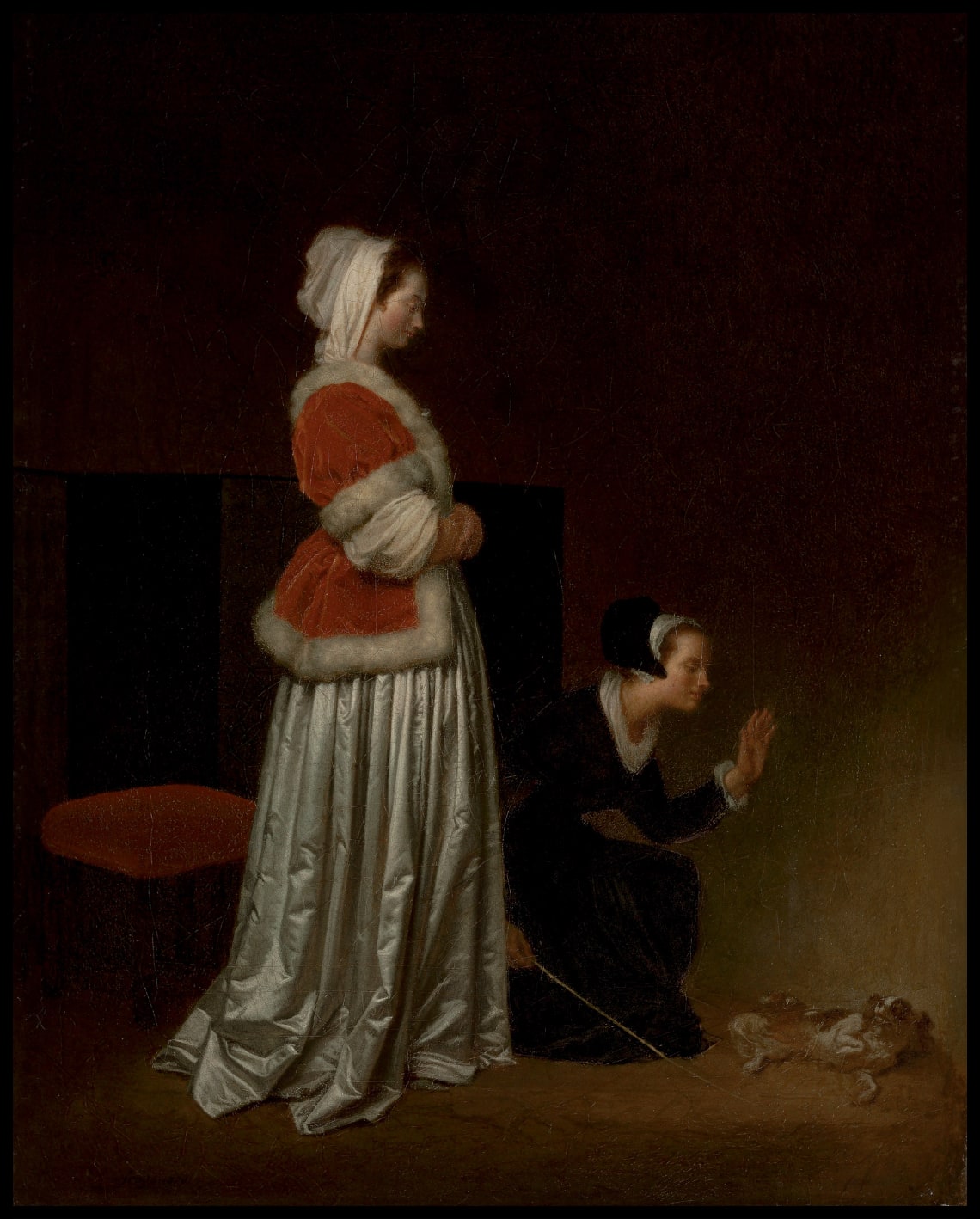 A lady and her maid chastising a spaniel