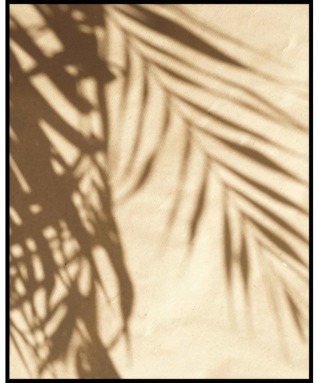 Ein Poster vom Schatten einzelner Palmenblätter auf einer beigefarbenen Häuserfassade.