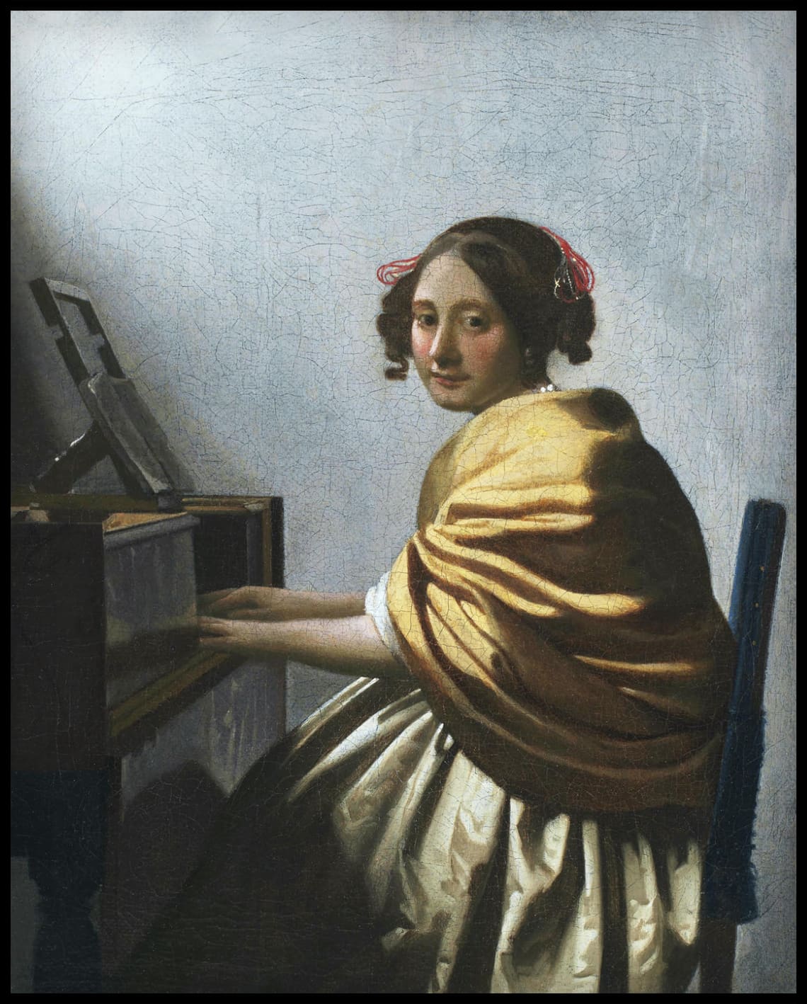 Une jeune femme assise à un virginal