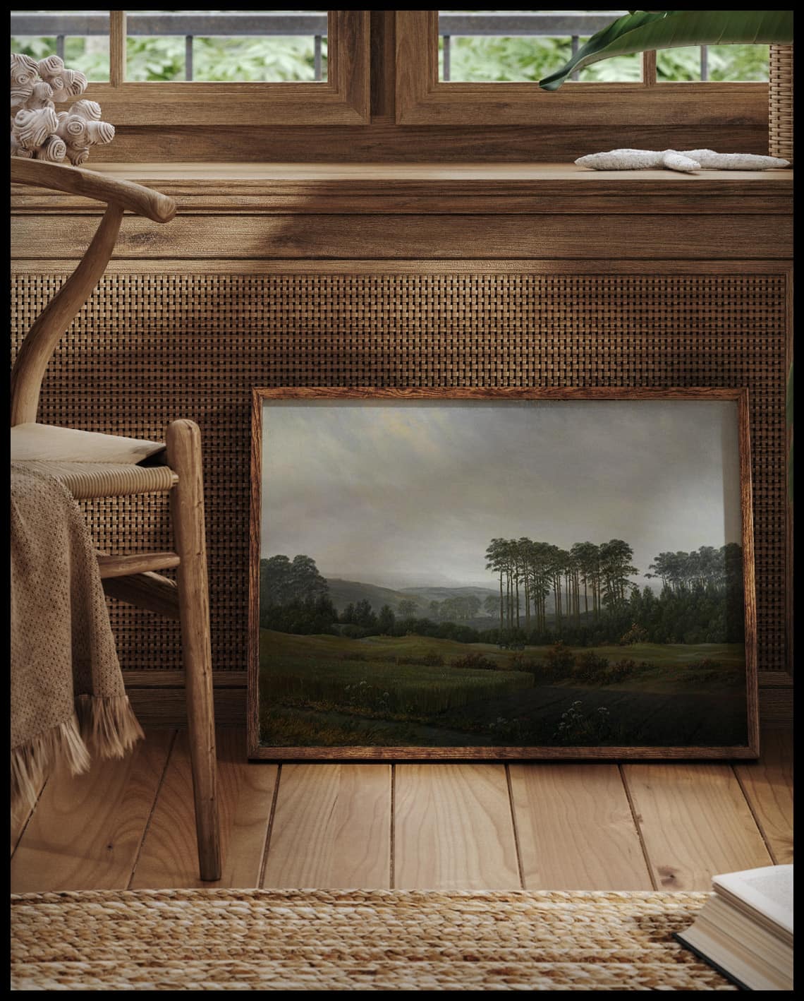 Ein gerahmter Kunstdruck von einer weiten, Landschaft am Nachmittag, vor einem Fenster an die Wand angelehnt