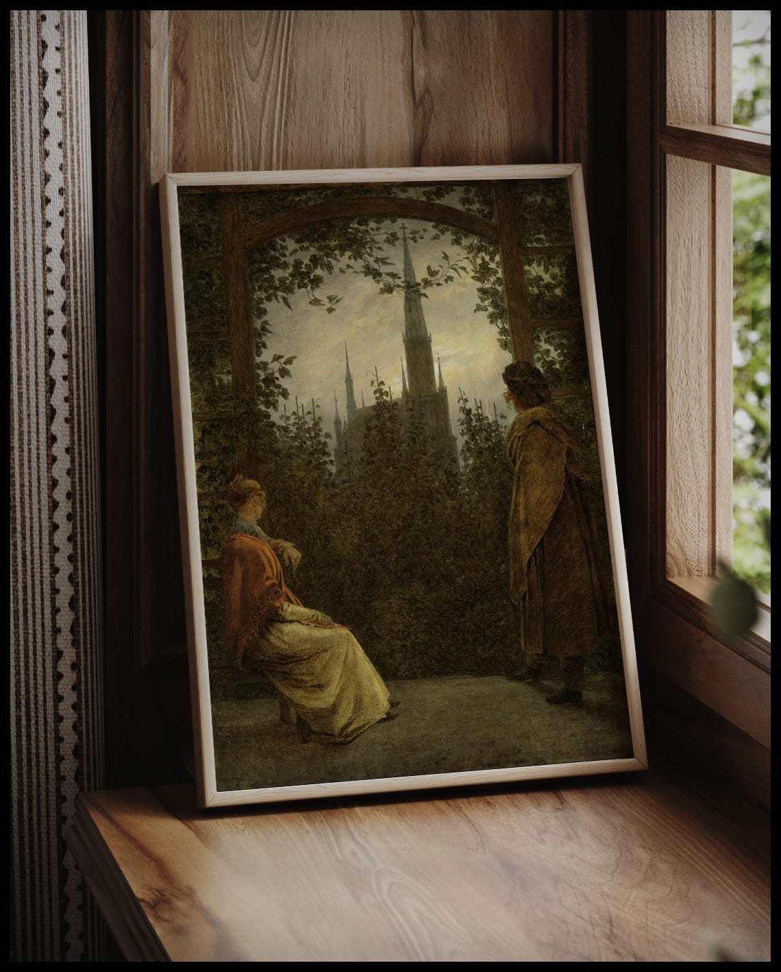 Ein Kunstdruck einer Frau und eines Mannes in einer Gartenlaube mit Blick auf eine gotische Kirche, vor einem Fenster an die Wand angelehnt
